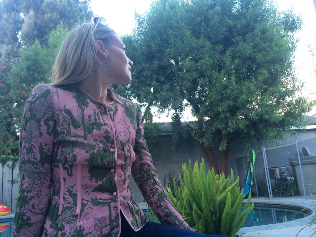 a woman in a pink and green blazer