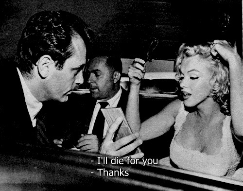 Marlin Monroe accepts a drink from a man while sitting next to Sammy Davis Jr. Text: I love You. Thanks