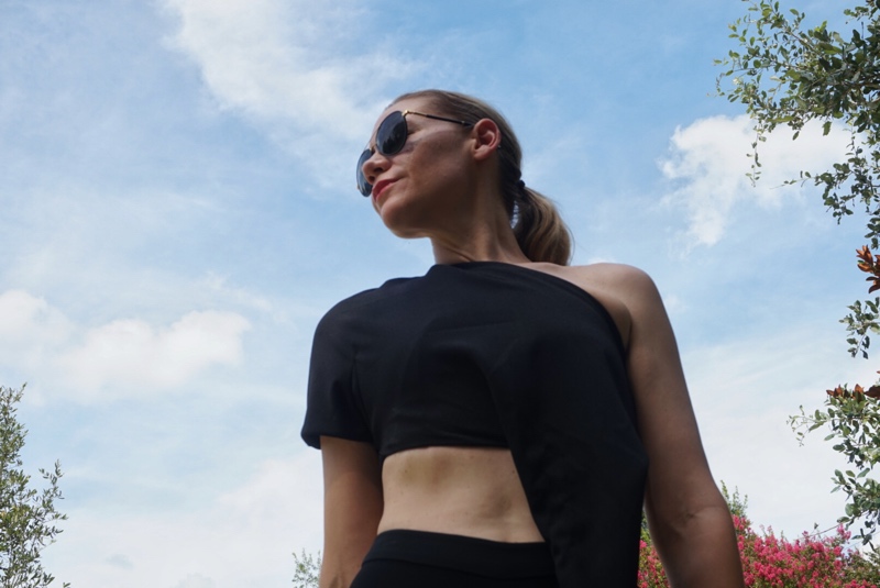 a close up of a woman in a black crop top