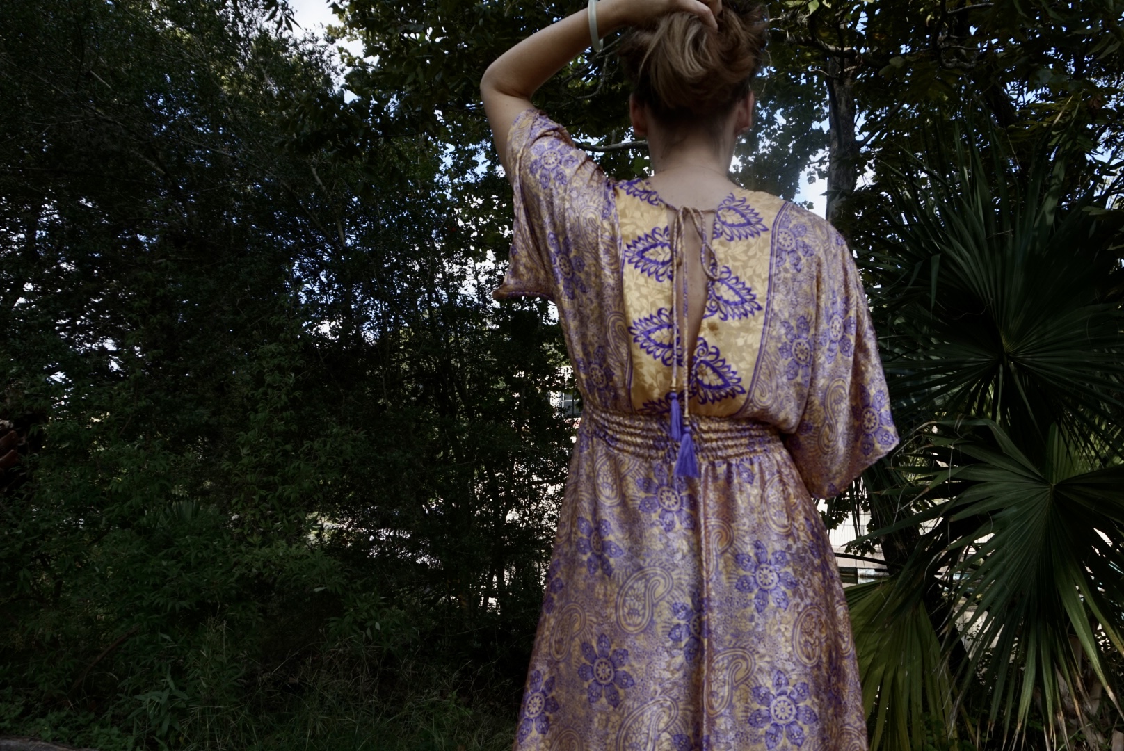a woman in a gold and purple caftan
