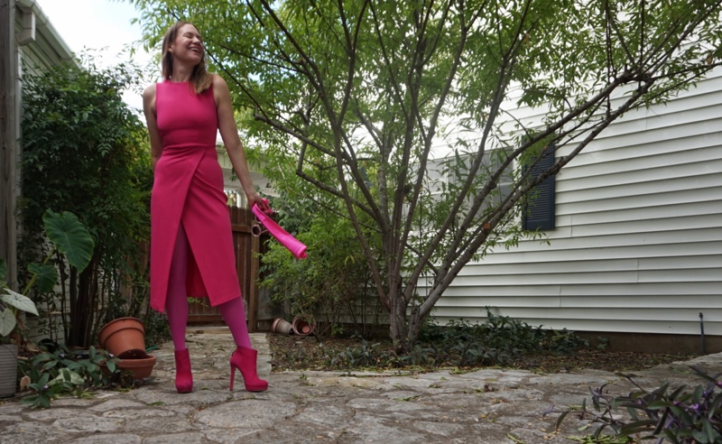 a woman in a hot pink dress, tights, boots and gloves