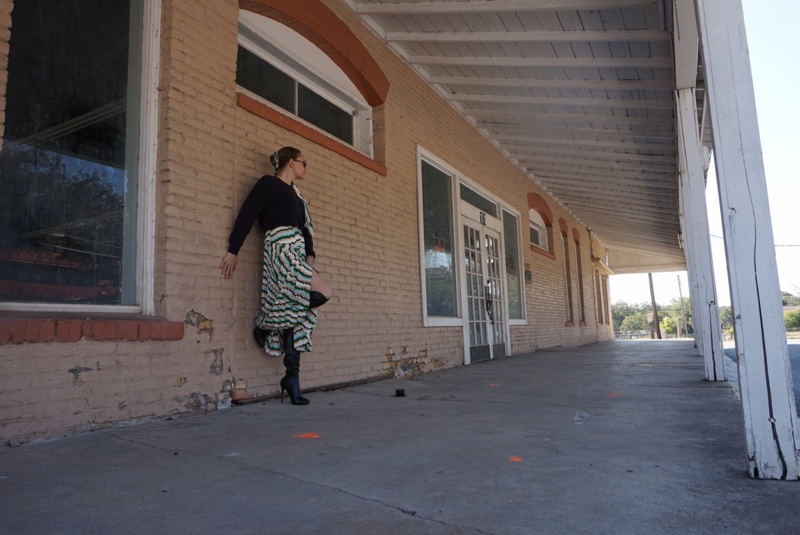 a woman in a printed pleated skirt sweater and skirt