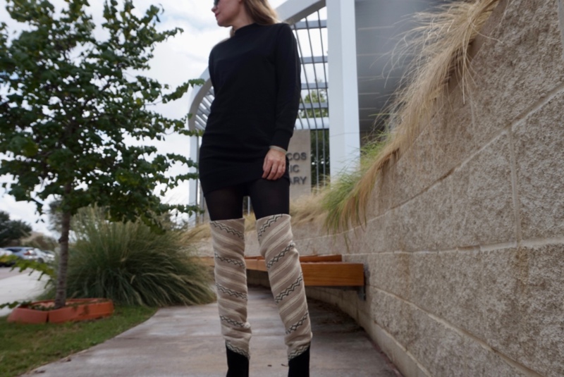 a woman in a sweatshirt dress, tights, and over the knee boots