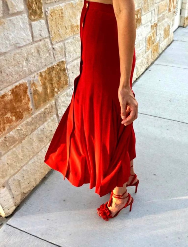 close up of a woman in a red skirt and red fringe heels