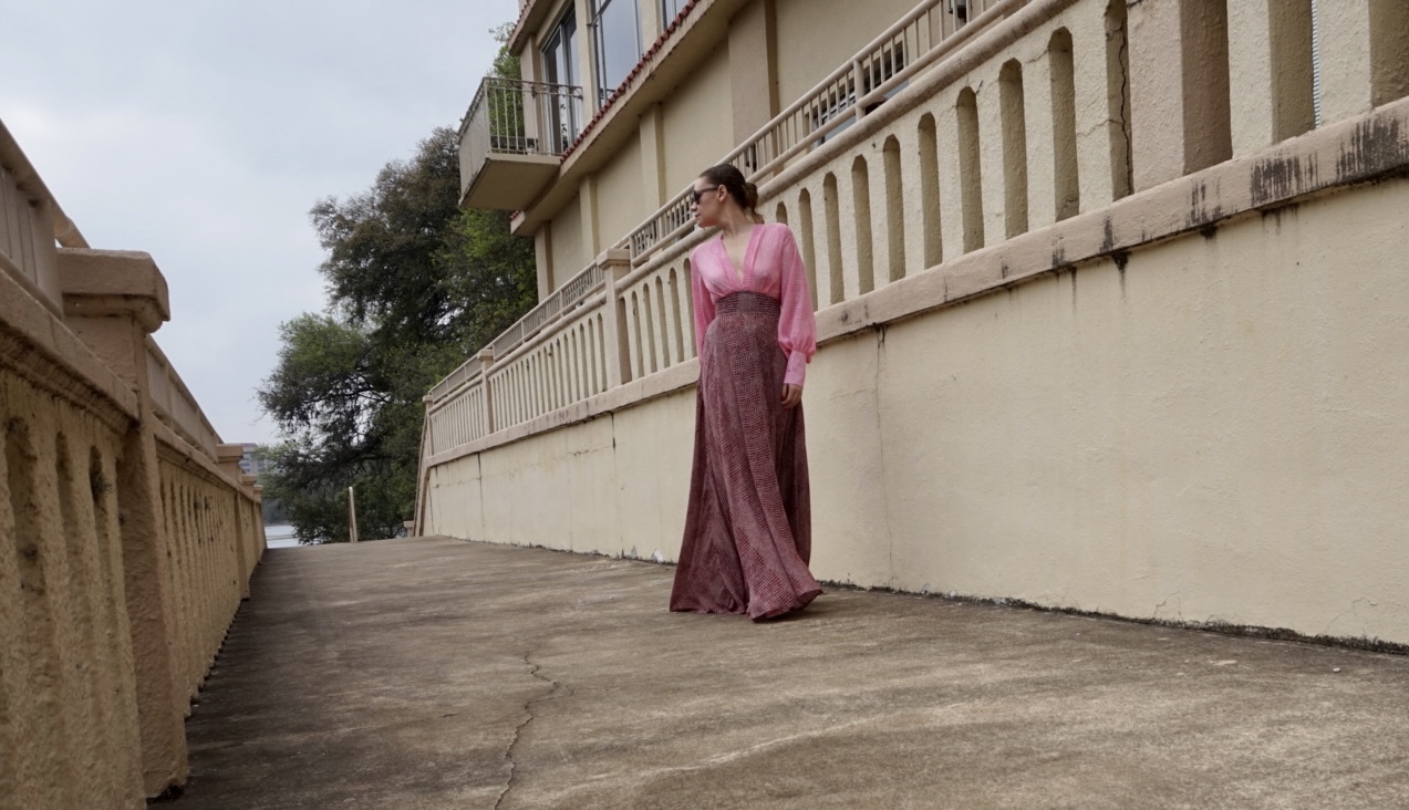 a woman in a red and pink maxi gown with pink wedges