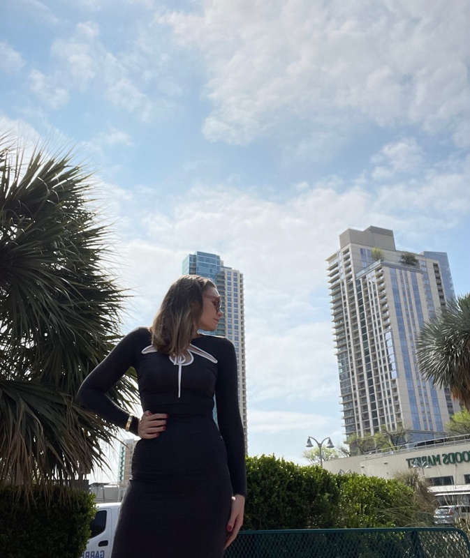 a woman in a jersey dress with a skyscraper background 