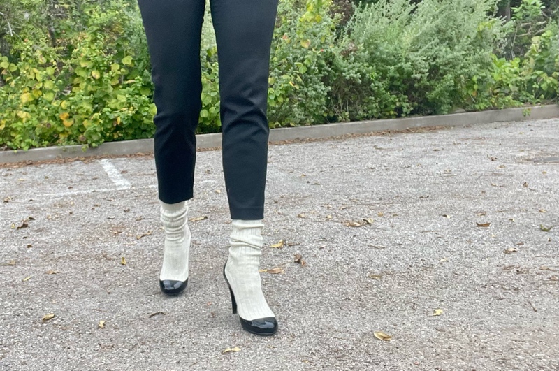 a close up of white sock boots and black cropped pants