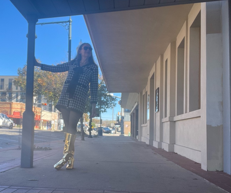 a woman in a mini houndstooth tweed dress and gold wedge boots