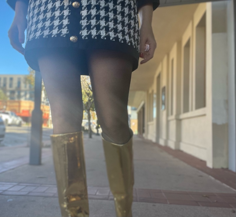 a woman in a mini houndstooth tweed dress and gold metallic boots