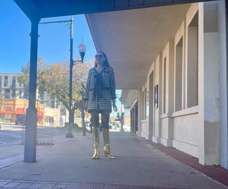 a woman in a mini houndstooth tweed dress and gold metallic boots