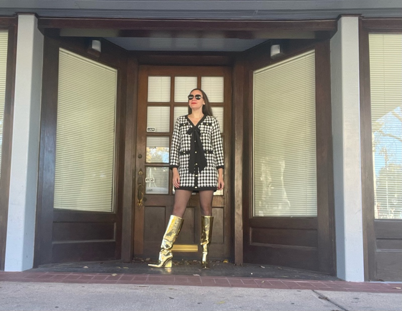a woman in a mini houndstooth tweed dress and gold wedge boots