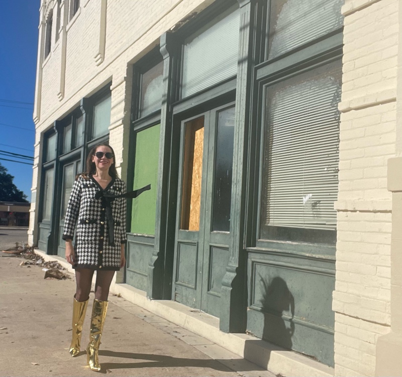 a woman with a mini houndstooth tweed dress with tie and gold wedge knee high boots 