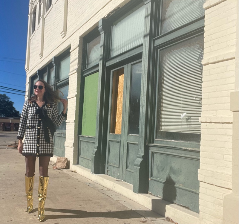 a woman in a mini houndstooth tweed dress and gold wedge boots