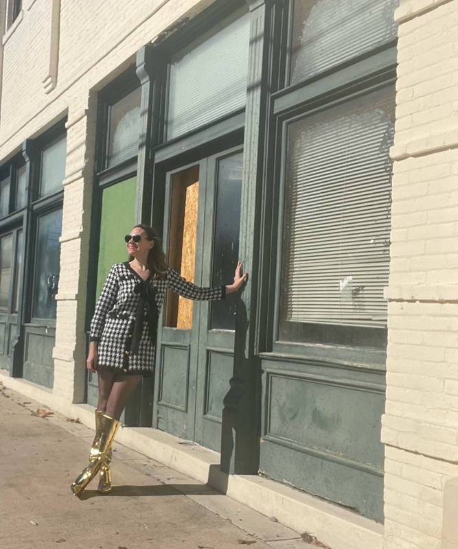 a woman in a mini houndstooth tweed dress and gold wedge boots