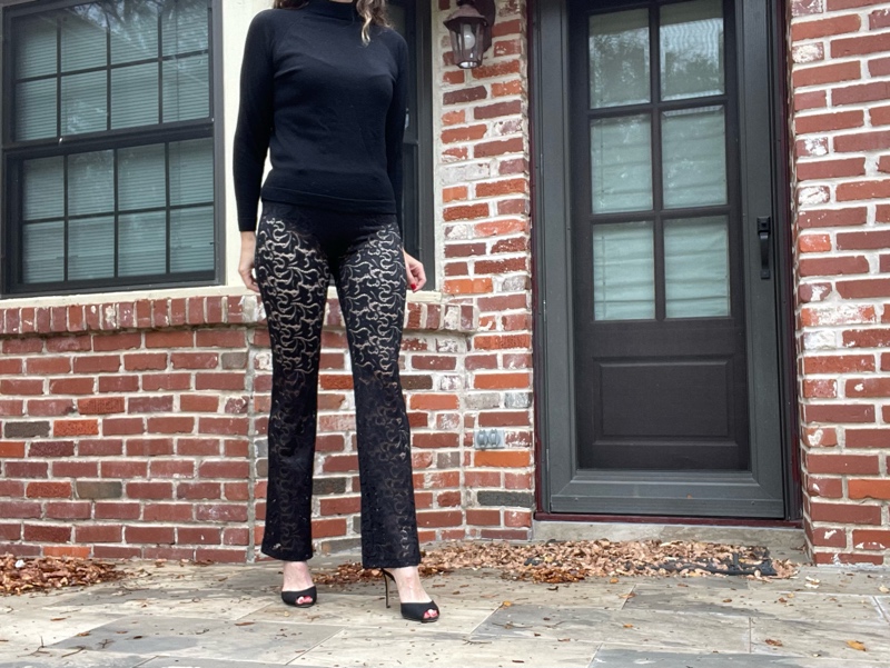 a woman in black turtleneck and sheer black lace pants  and black peep toe shoes