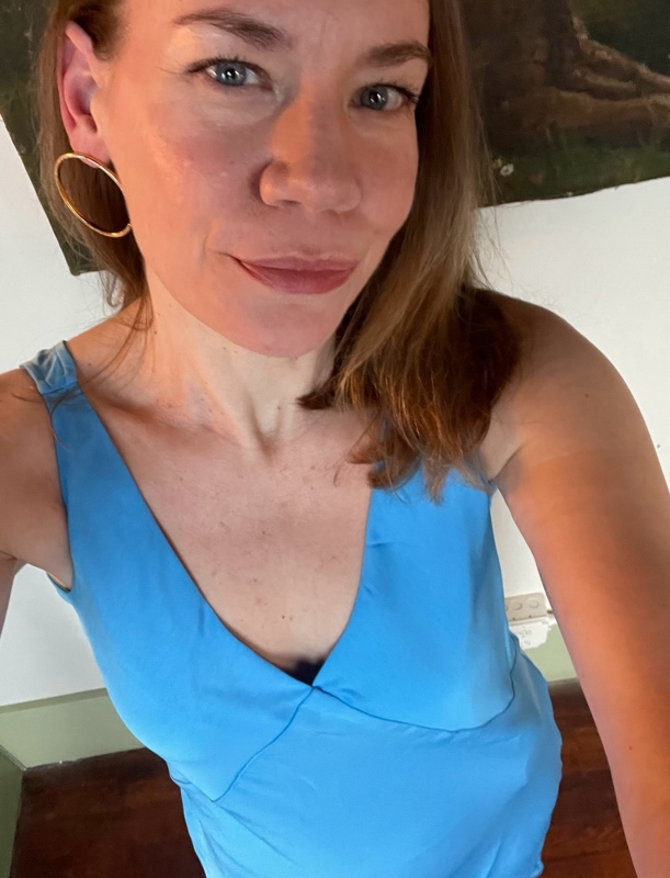 a woman in a blue slip dress, 