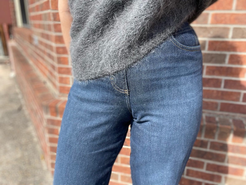 a close up of a woman in jeans