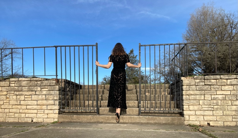 a woman in a burnout velvet vintage dress with a swimsuit underneath and wedge shoes