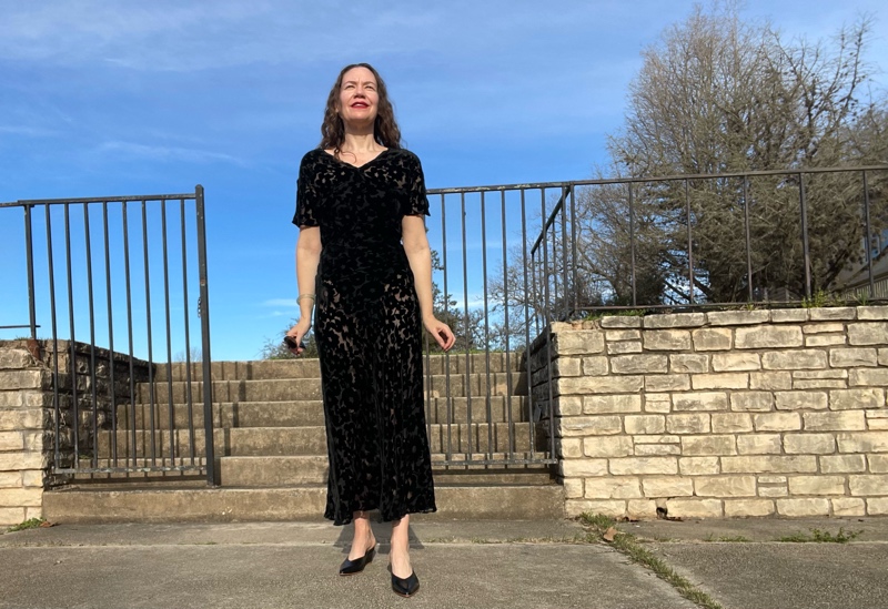 a woman in a vintage burn out velvet dress with a swim suit underneath and wedge shoes