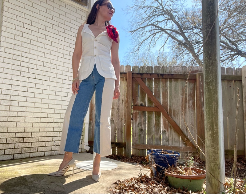 a woman in a white vest and a red floral borsch and denim and white chino  mix pants and white heels