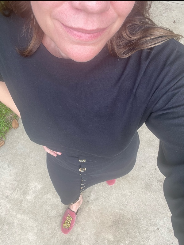 a woman in a slit jersey button dress and pink mules