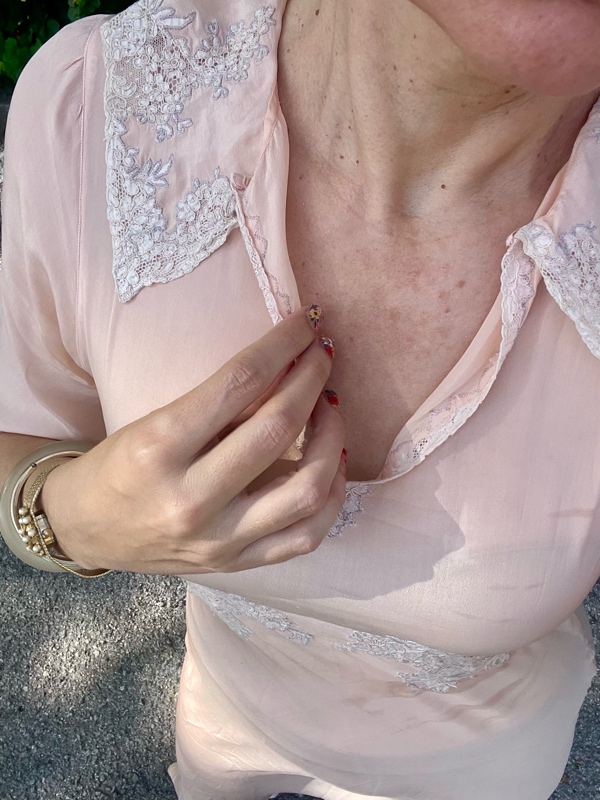 a woman in a vintage peach night gown with flat sandals with fruit charms