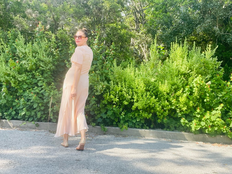 a woman in a 1930 nightgown and modern fruit sandals